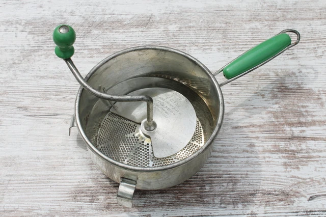 Foley food mill — silver metal with green wooden grips