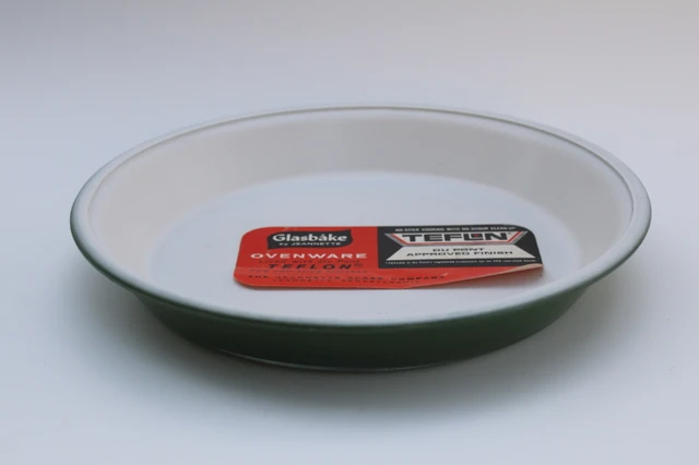 Avocado pie plate with original label — dark avocado green exterior and white nonstick interior