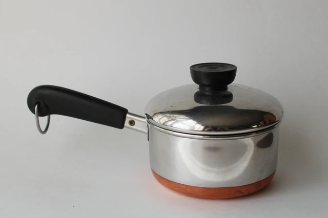Copper-bottom covered saucepan — silver metal with copper bottom and black handle